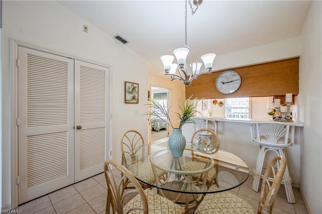 1325 Mainsail Drive, Unit 1213 Naples, FL 34114 - Photo 10 of 40 a view of a dining room with furniture