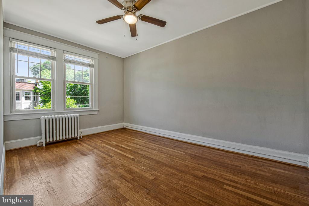2406 37th Street Northwest Washington, DC 20007 - Photo 36 of 44 wooden floor in an empty room with a window