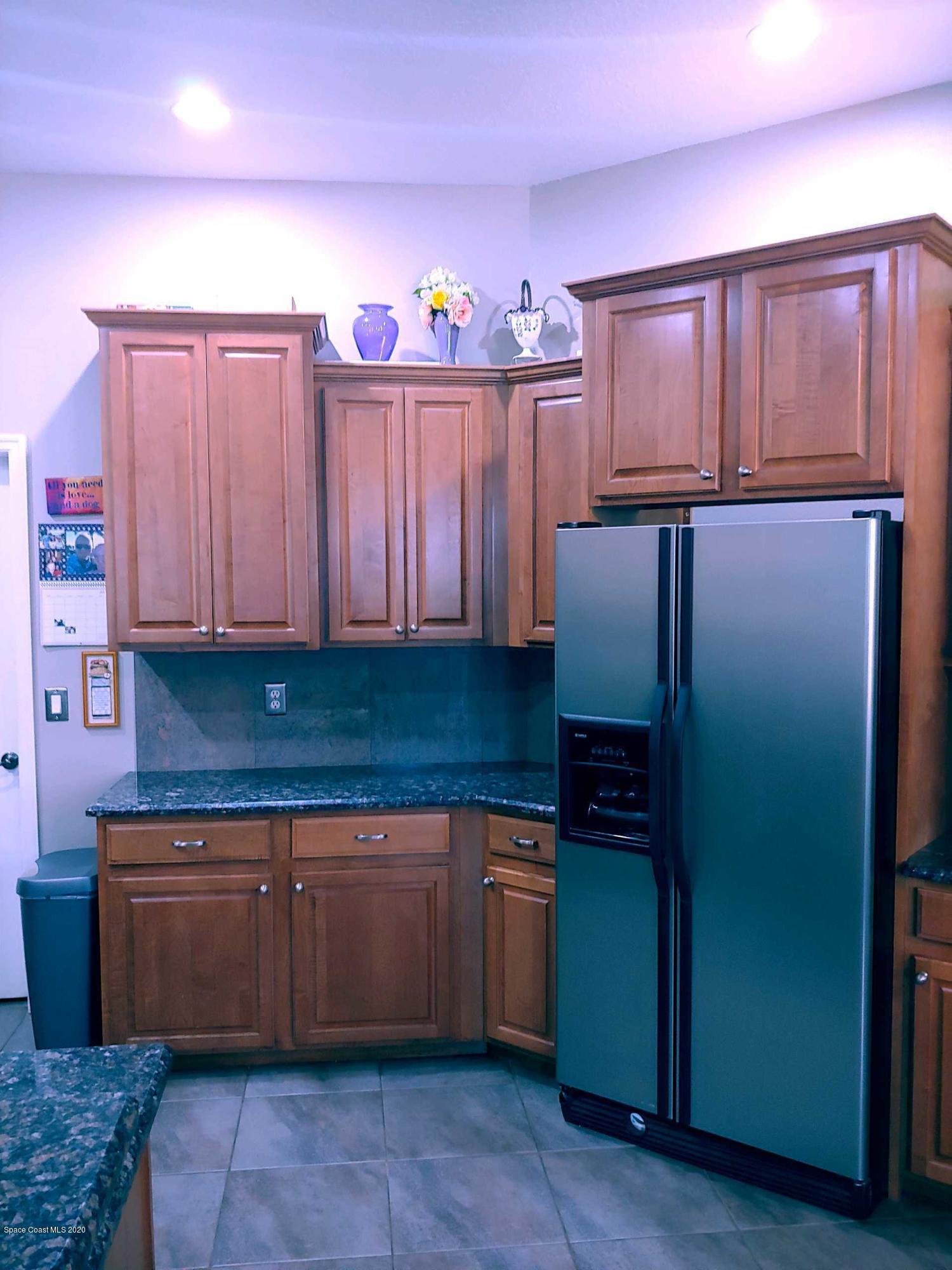 6791 Hartford Road Cocoa, FL 32927 - Photo 16 of 43 a kitchen with stainless steel appliances granite countertop a refrigerator and a sink