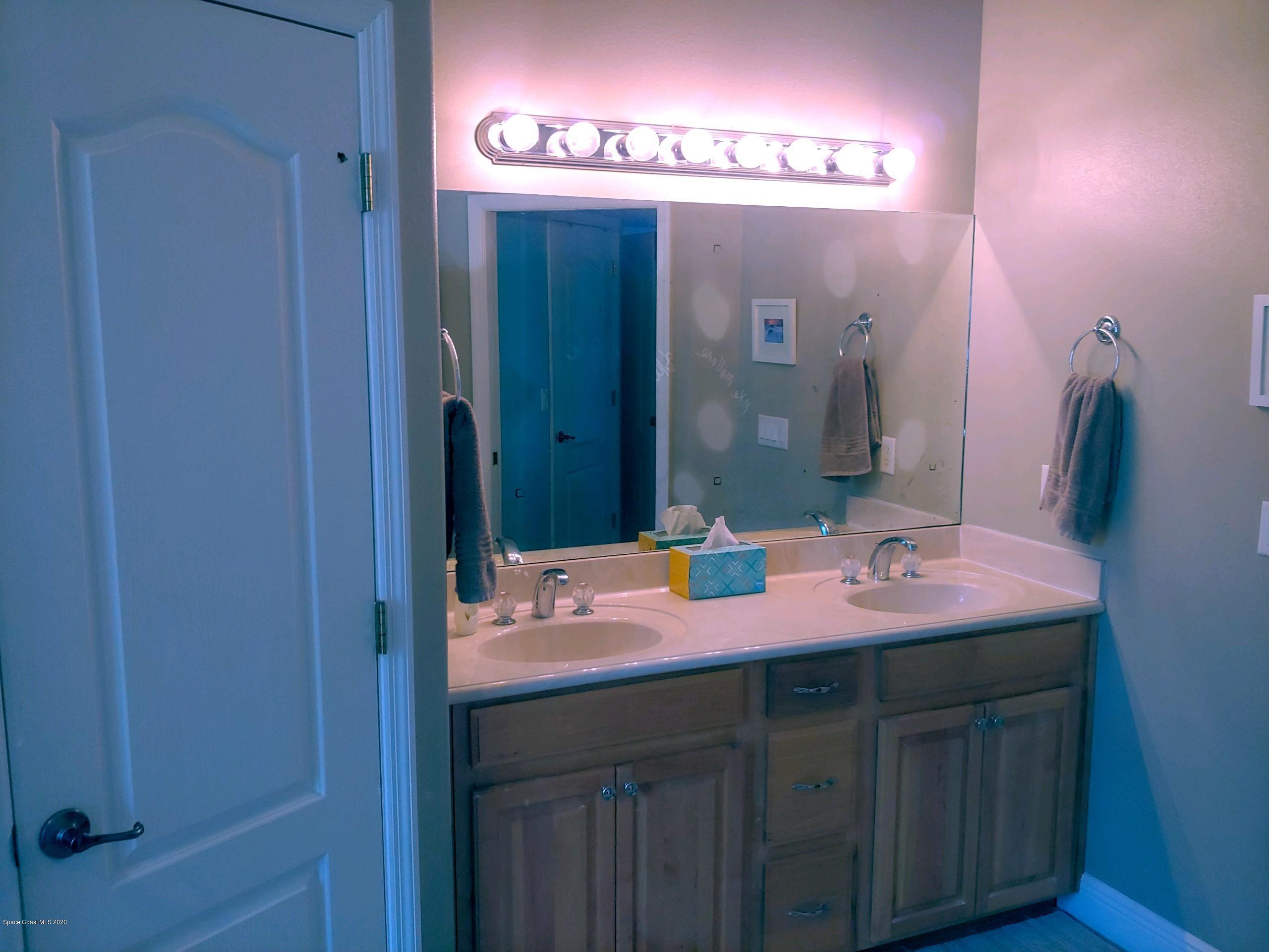6791 Hartford Road Cocoa, FL 32927 - Photo 23 of 43 a bathroom with a sink and a mirror