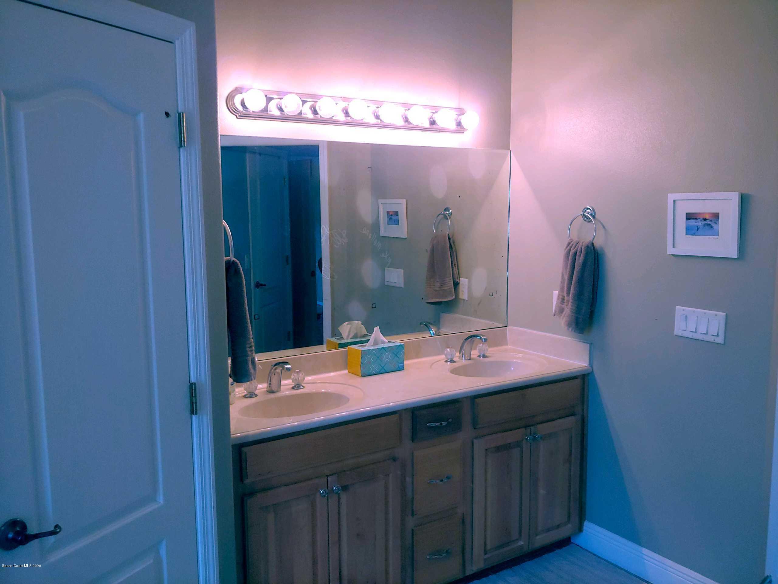 6791 Hartford Road Cocoa, FL 32927 - Photo 25 of 43 a bathroom with a sink and a mirror