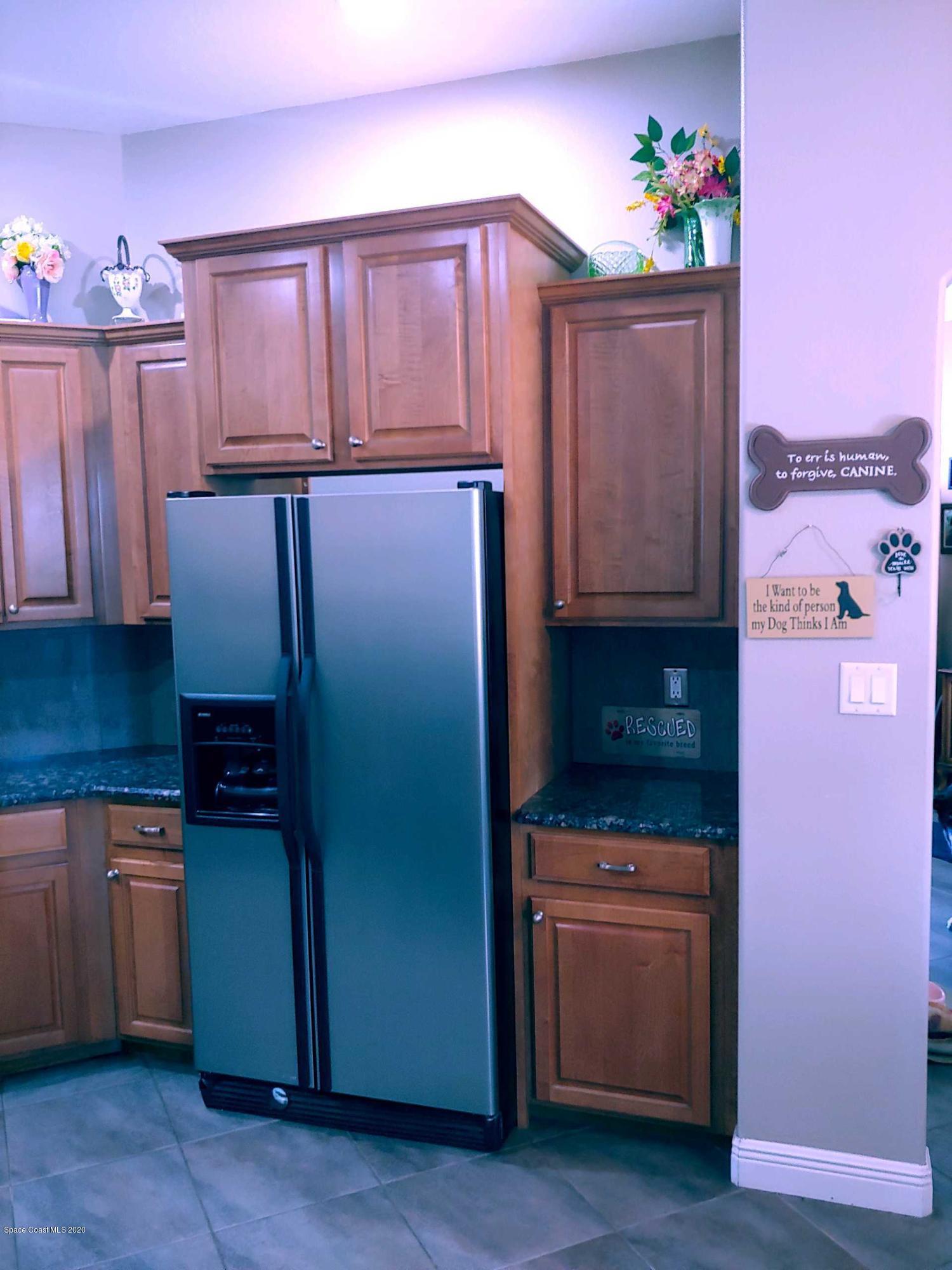 6791 Hartford Road Cocoa, FL 32927 - Photo 26 of 43 a kitchen with stainless steel appliances a refrigerator and a stove