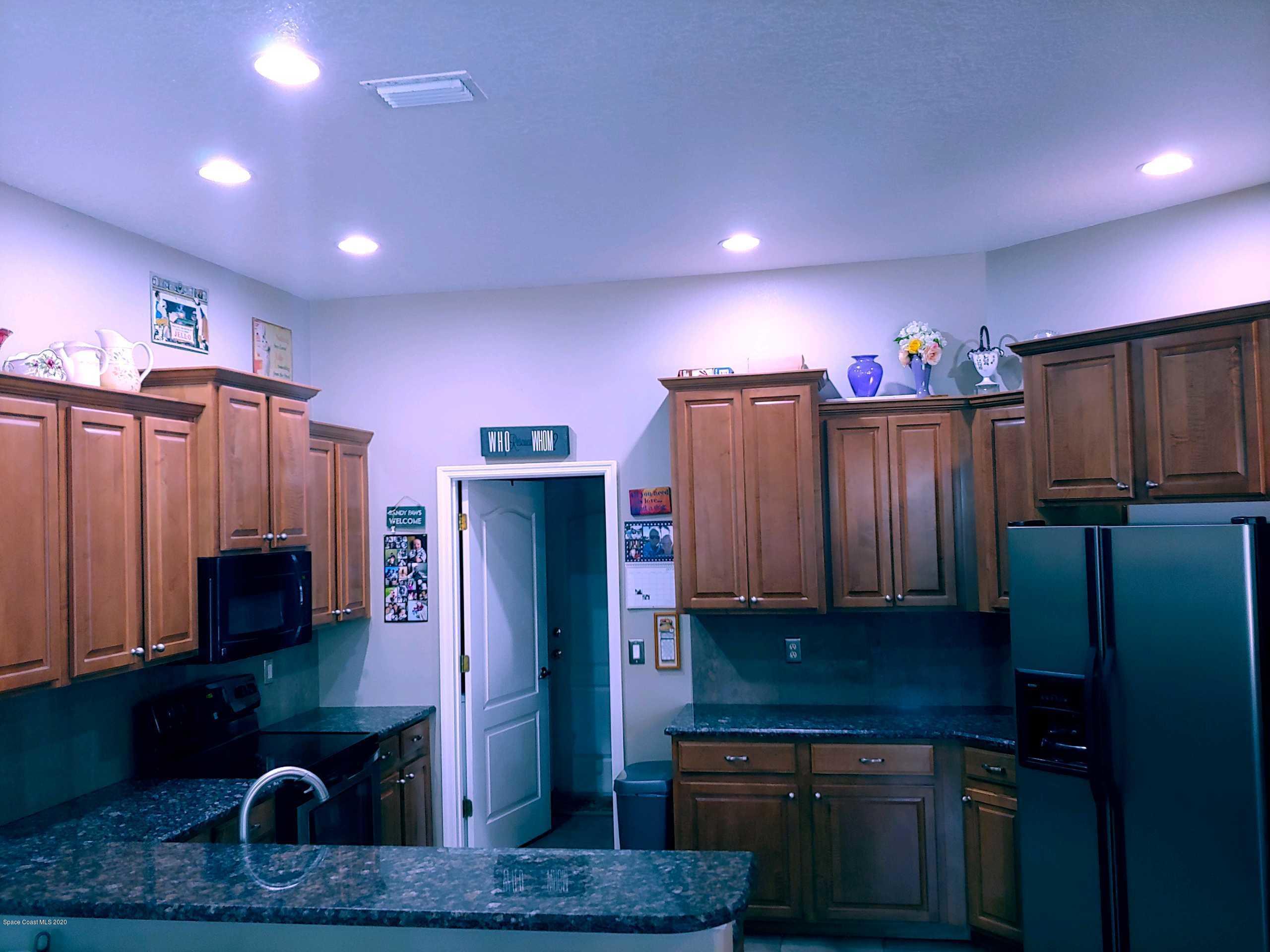 6791 Hartford Road Cocoa, FL 32927 - Photo 27 of 43 a kitchen with stainless steel appliances granite countertop a refrigerator and a sink