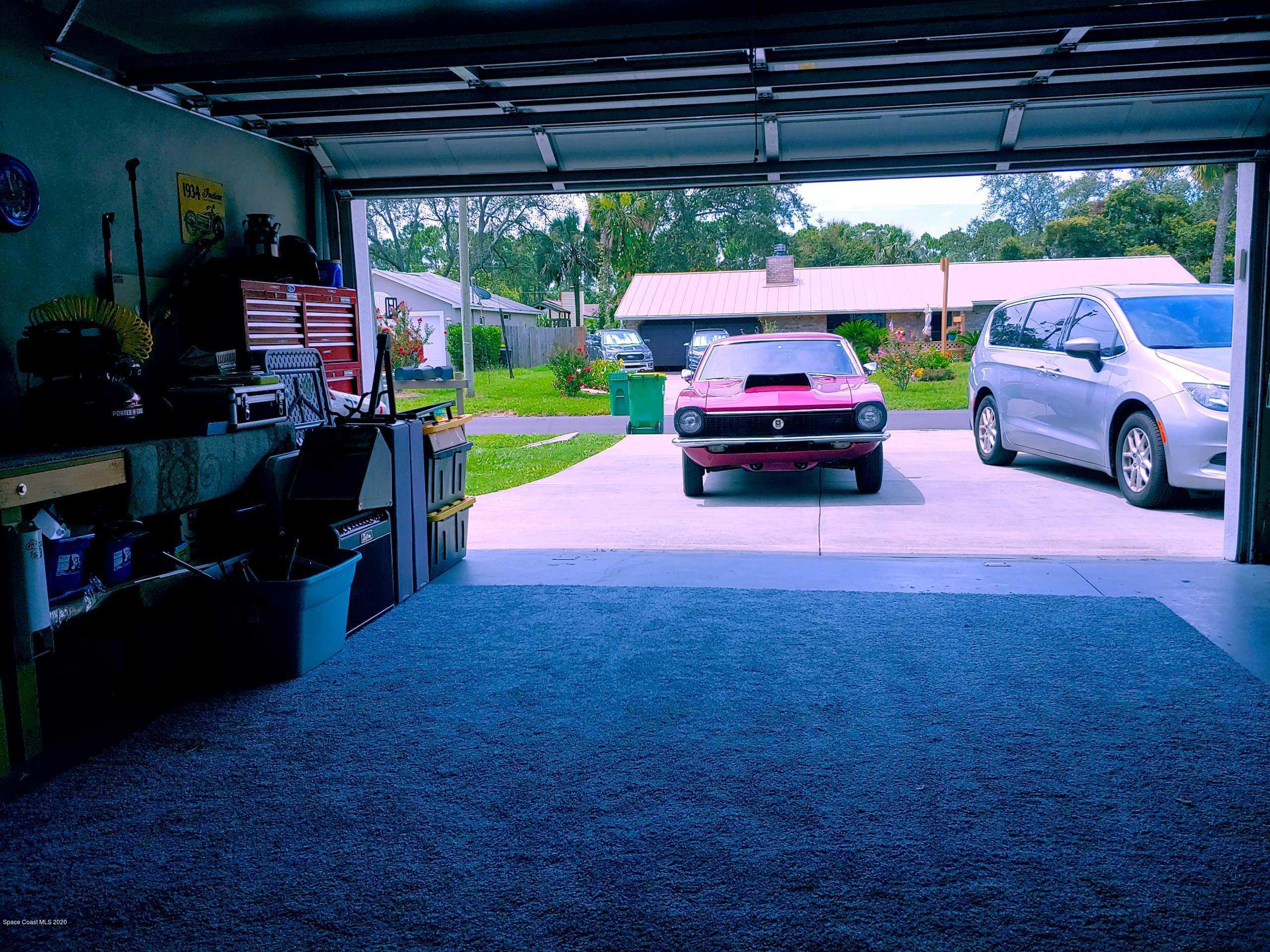 6791 Hartford Road Cocoa, FL 32927 - Photo 35 of 43 a car parked in front of a house with a yard