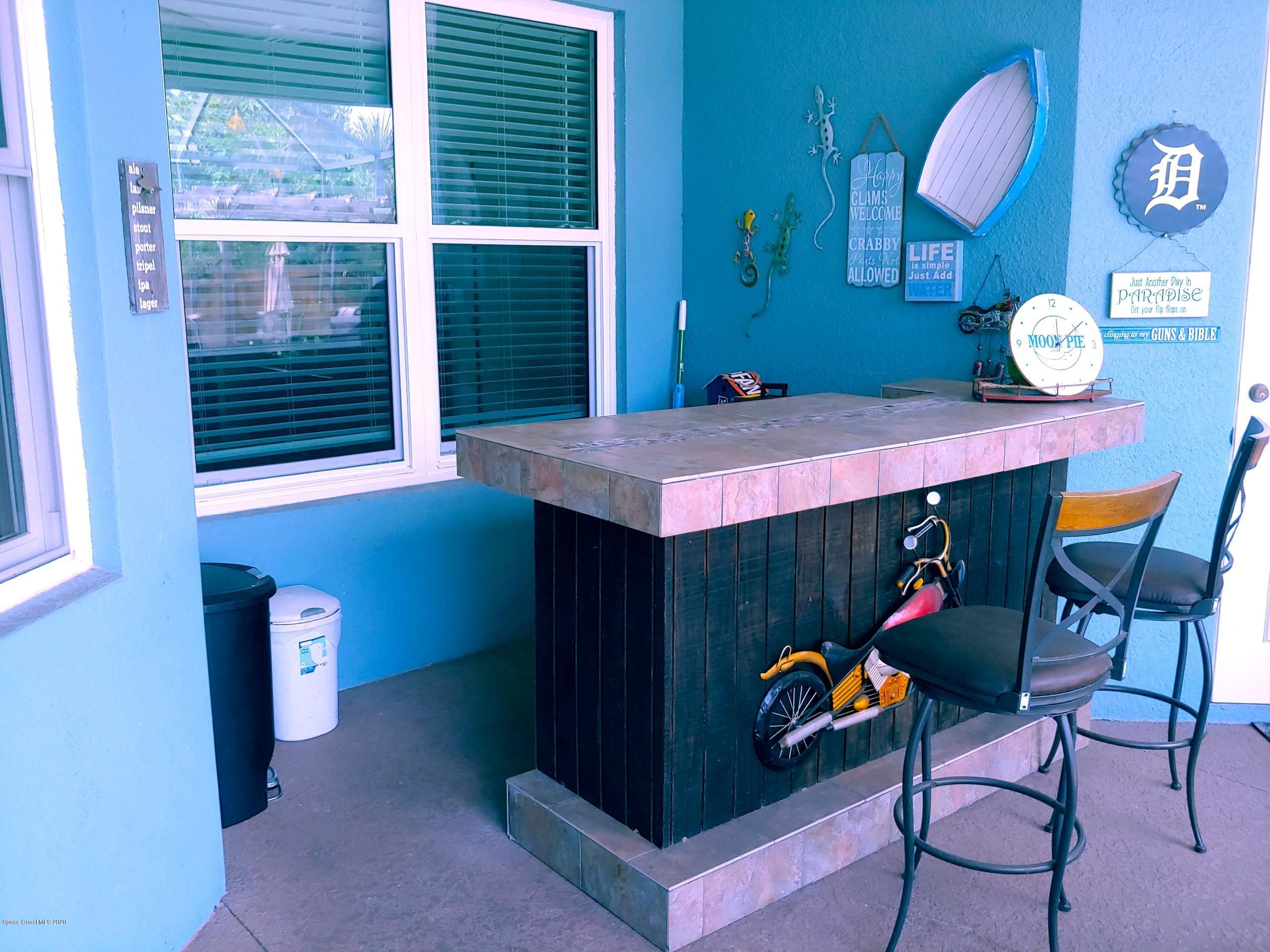 6791 Hartford Road Cocoa, FL 32927 - Photo 38 of 43 a dining room with a table and chairs