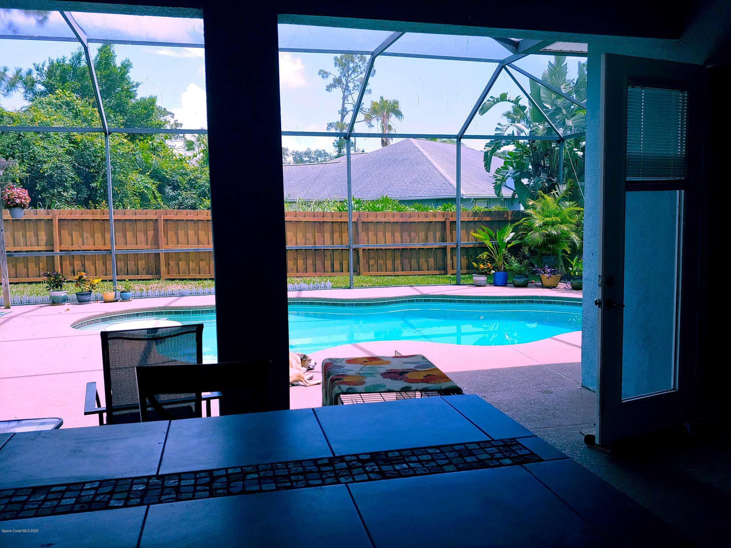 6791 Hartford Road Cocoa, FL 32927 - Photo 41 of 43 a view of a backyard with a table and chairs potted plants