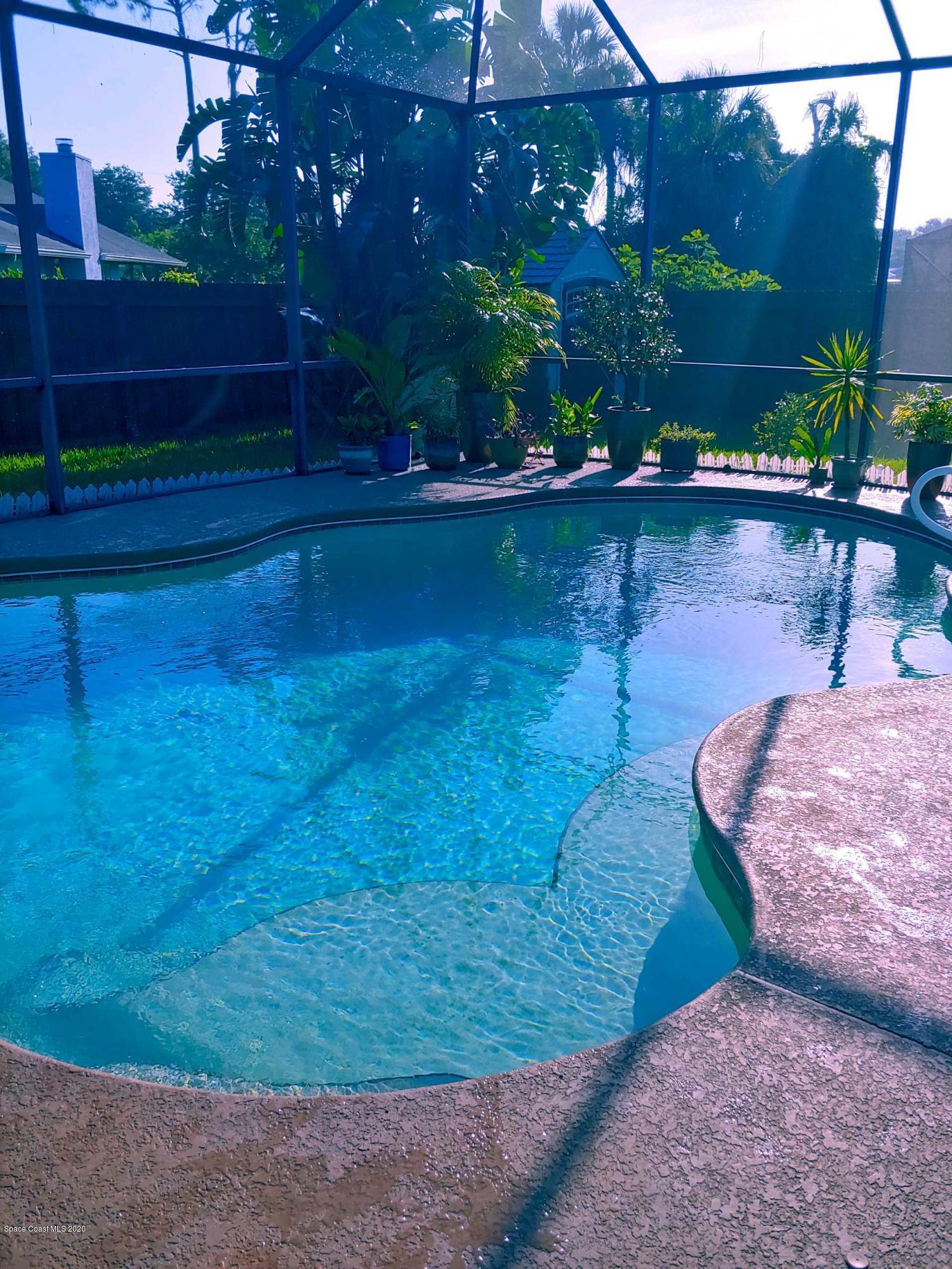 6791 Hartford Road Cocoa, FL 32927 - Photo 10 of 43 a swimming pool with wooden fence