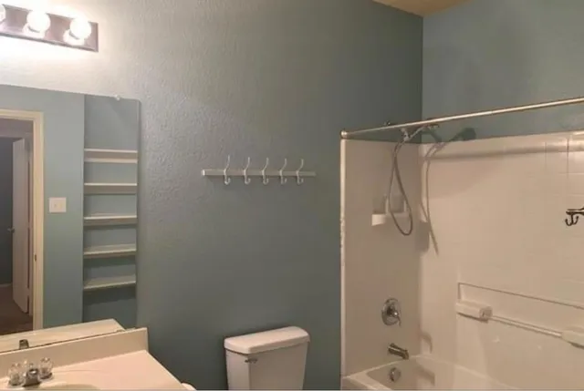a bathroom with a shower and a toilet