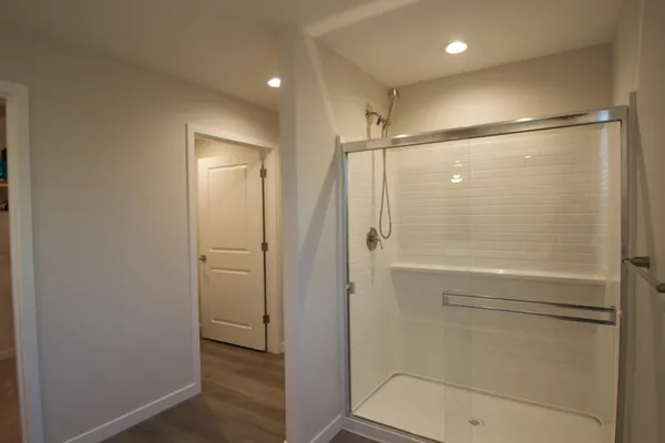a bathroom with a shower and a glass door