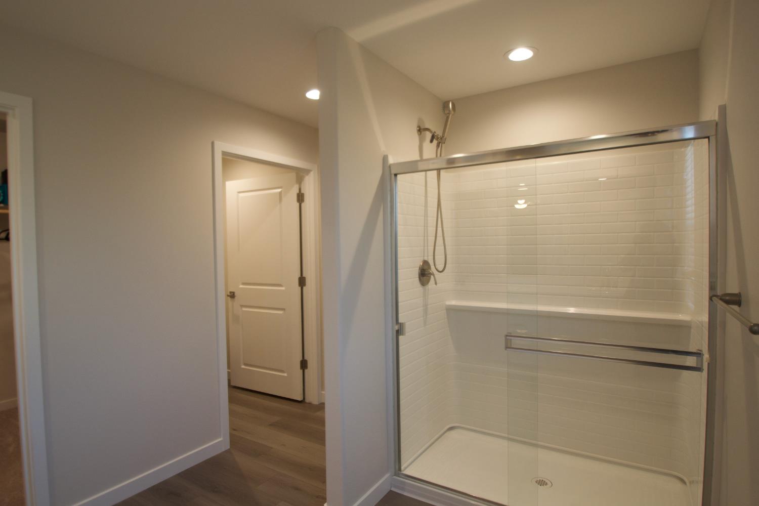 4154 Constance Road Madera, CA 93636 - Photo 11 of 23 a bathroom with a shower and a glass door