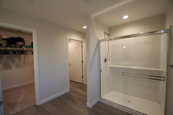 a bathroom with a shower and a glass door