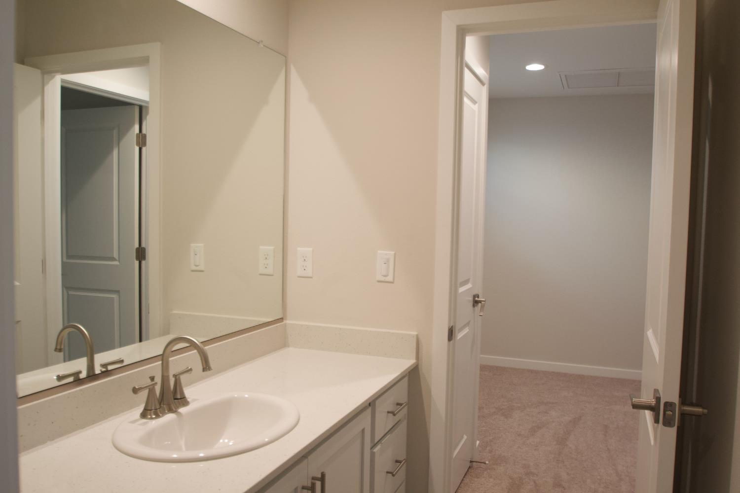 4154 Constance Road Madera, CA 93636 - Photo 16 of 23 a bathroom with a sink and a mirror