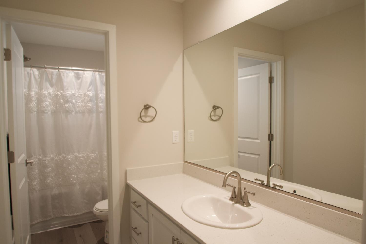 4154 Constance Road Madera, CA 93636 - Photo 22 of 23 a bathroom with a sink a toilet and shower