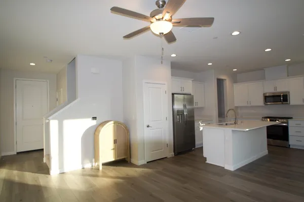 a view of kitchen with stainless steel appliances granite countertop cabinets and wooden floor