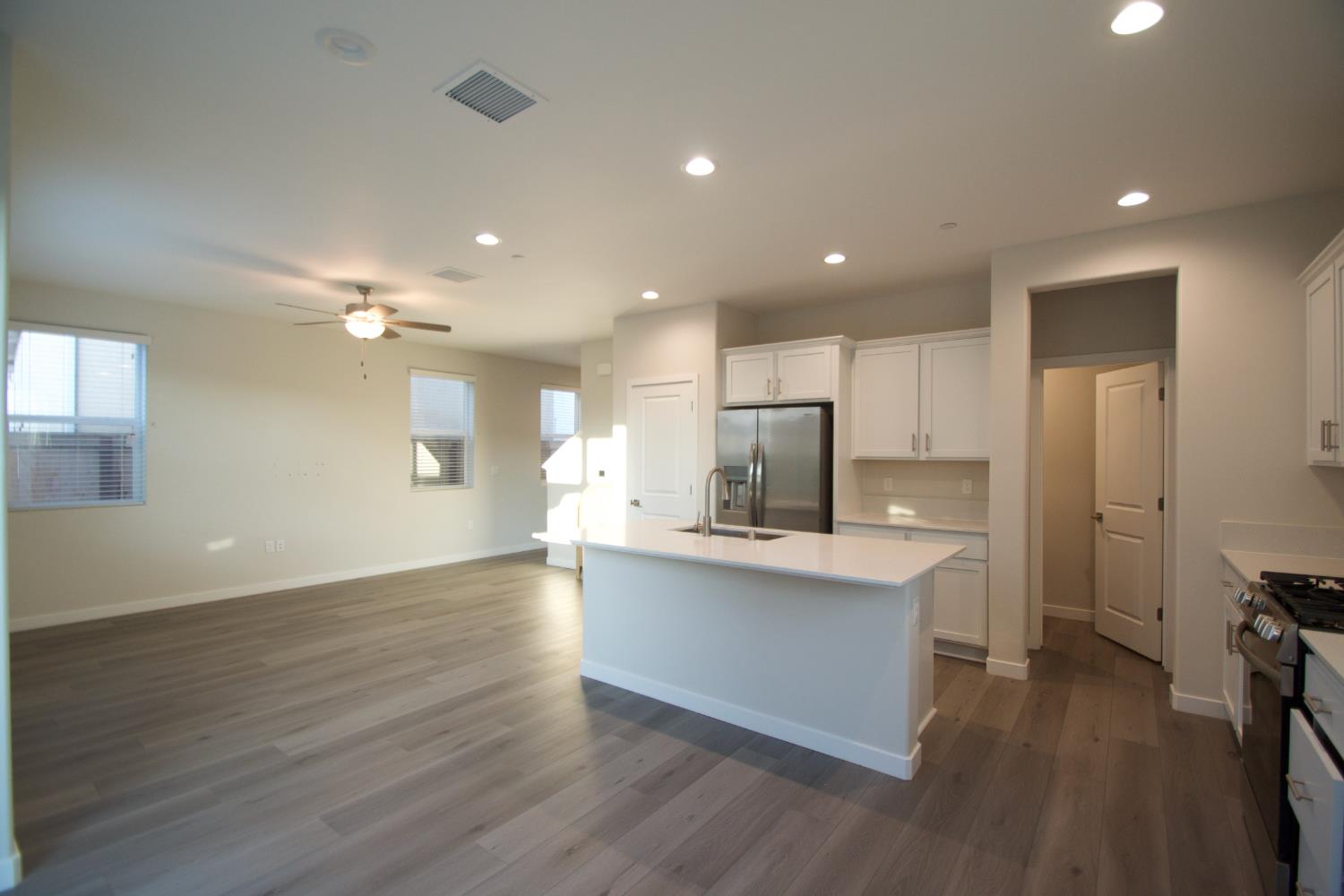4154 Constance Road Madera, CA 93636 - Photo 7 of 23 a view of kitchen with cabinets stainless steel appliances and wooden floor
