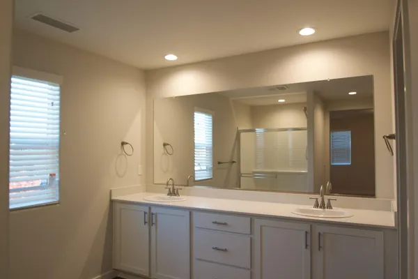 a bathroom with a double vanity sink and a mirror