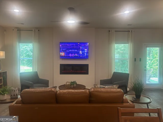 a living room with furniture a dining table and kitchen view