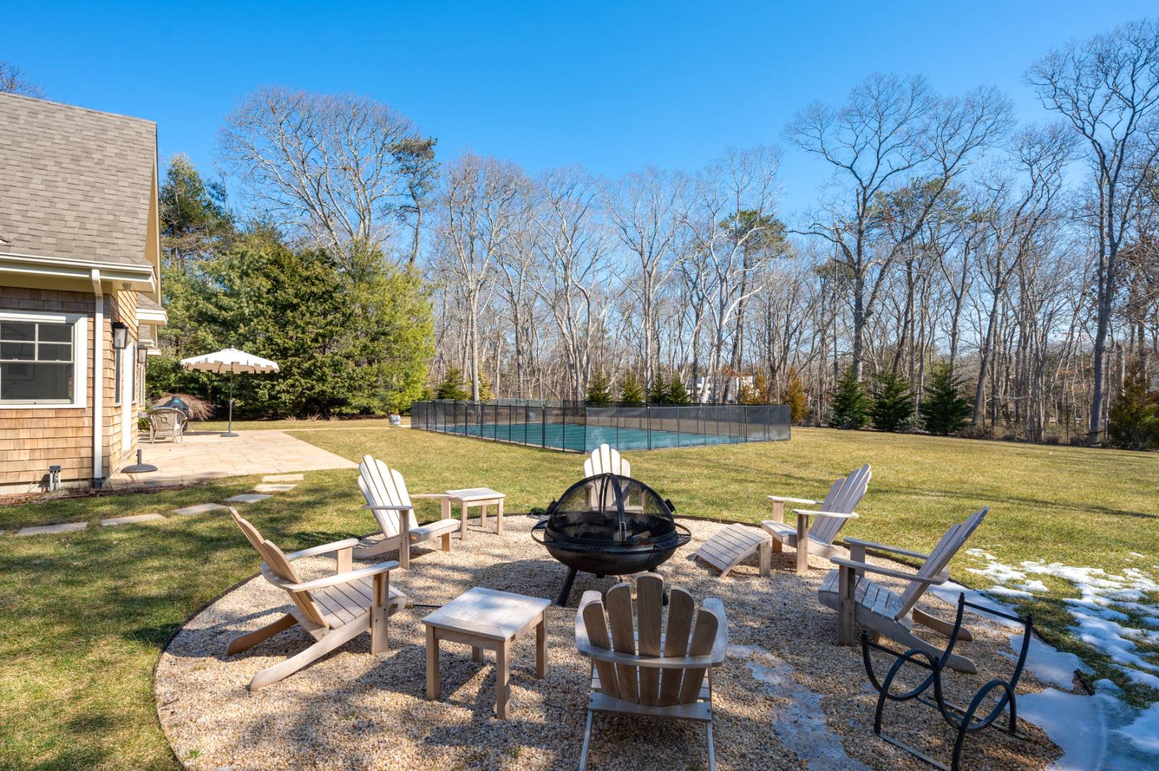 60 Jagger Lane Westhampton, NY 11977 - Photo 29 of 35 a view of a lake with table and chairs under an umbrella