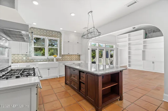 a kitchen with granite countertop a sink and cabinets