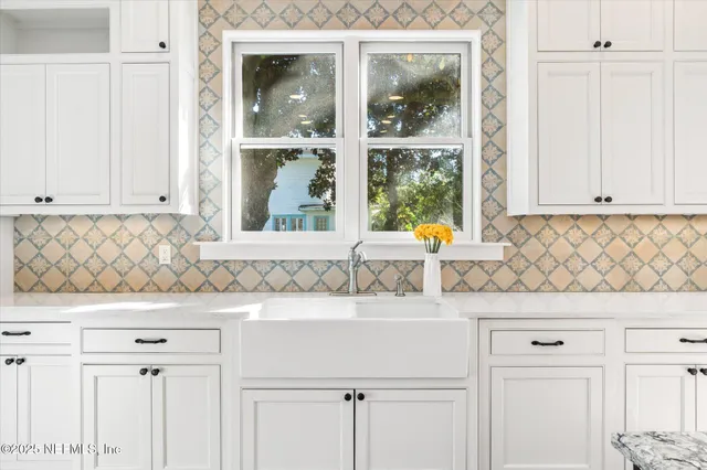 a bathroom with a tub sink shower and two mirror