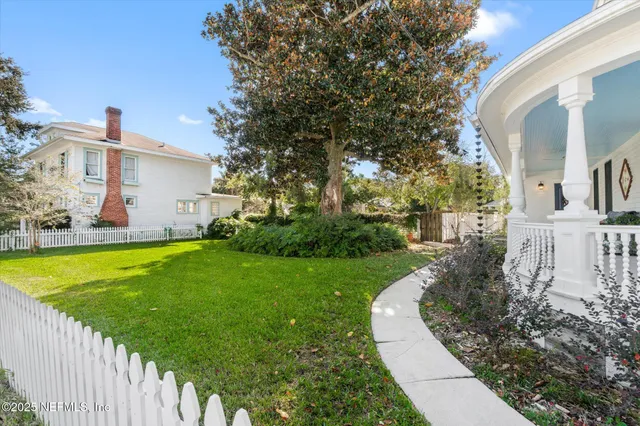 a front view of a house with a fence