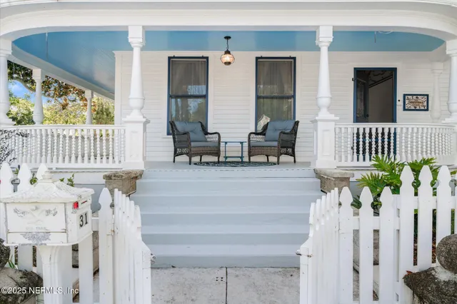 a view of a porch with chairs and backyard