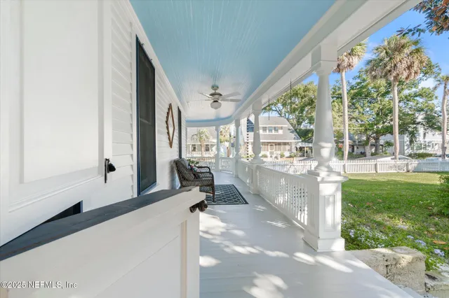 a view of hallway with a large window with wooden floor