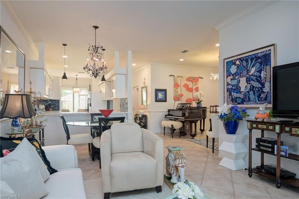 21533 Portrush Run Estero, FL 33928 - Photo 14 of 37 a living room with furniture and a flat screen tv