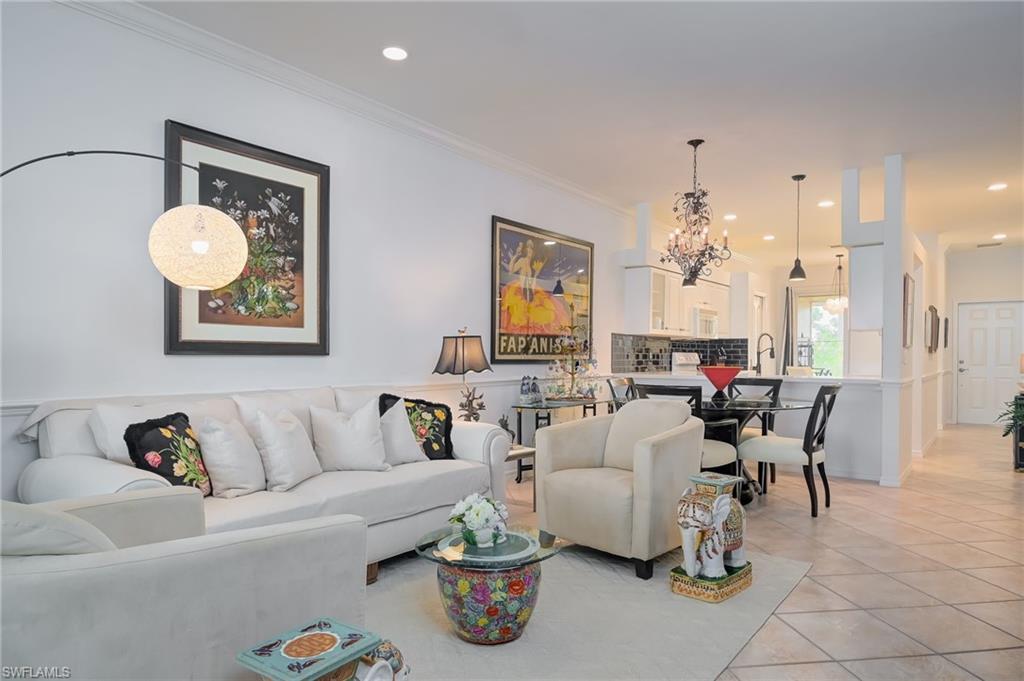 21533 Portrush Run Estero, FL 33928 - Photo 15 of 37 a living room with furniture flowerpot and a chandelier