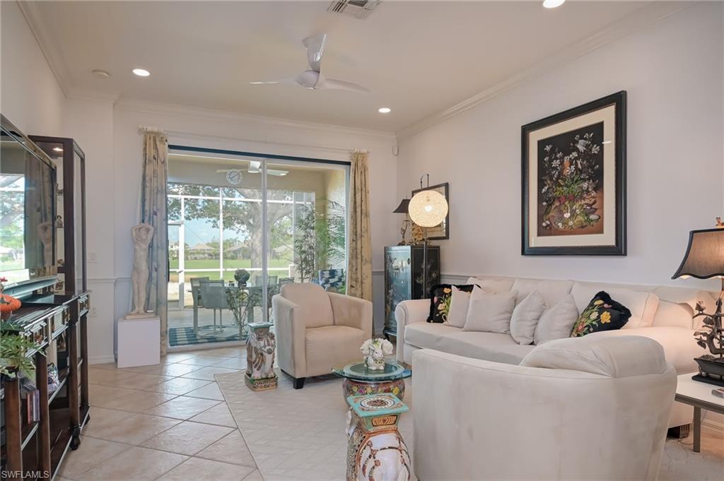 21533 Portrush Run Estero, FL 33928 - Photo 16 of 37 a living room with furniture and a flat screen tv