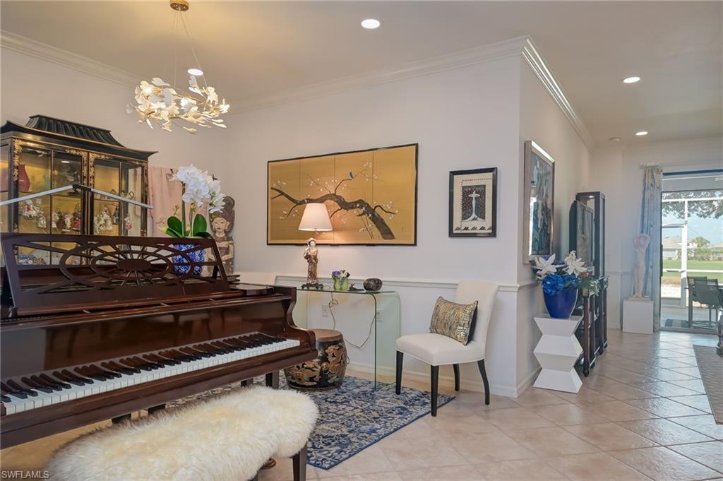 21533 Portrush Run Estero, FL 33928 - Photo 18 of 37 a living room with furniture a chandelier and a piano