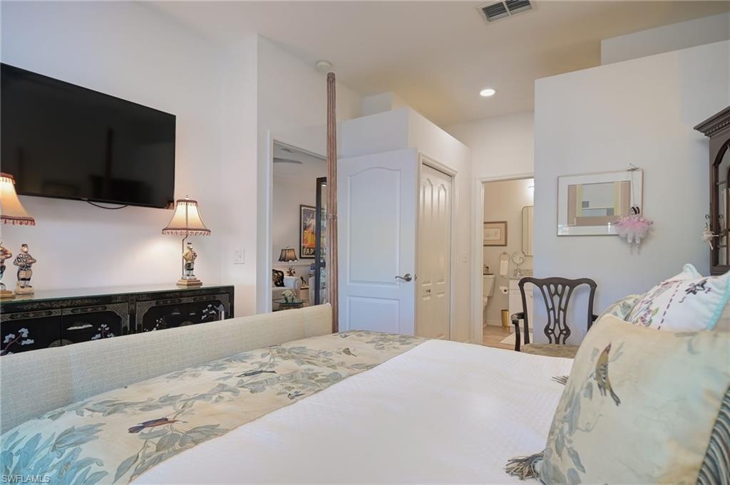 21533 Portrush Run Estero, FL 33928 - Photo 22 of 37 a bedroom with a bed and wooden floor