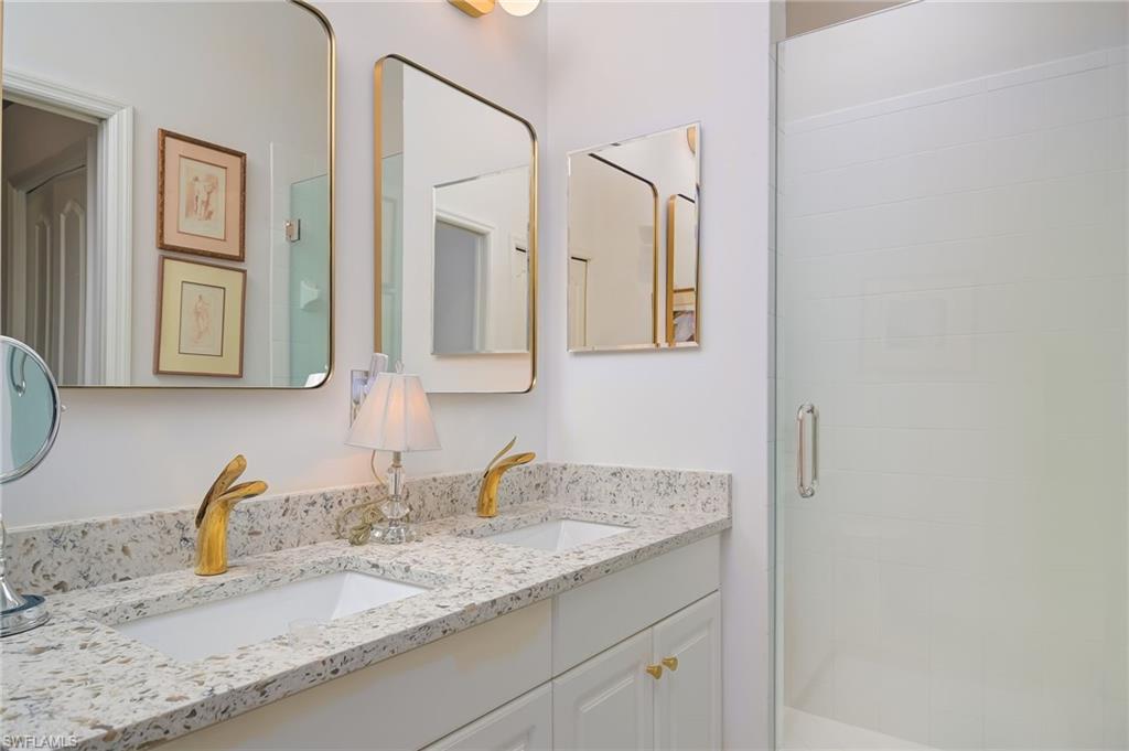 21533 Portrush Run Estero, FL 33928 - Photo 24 of 37 a bathroom with a granite countertop sink and a mirror