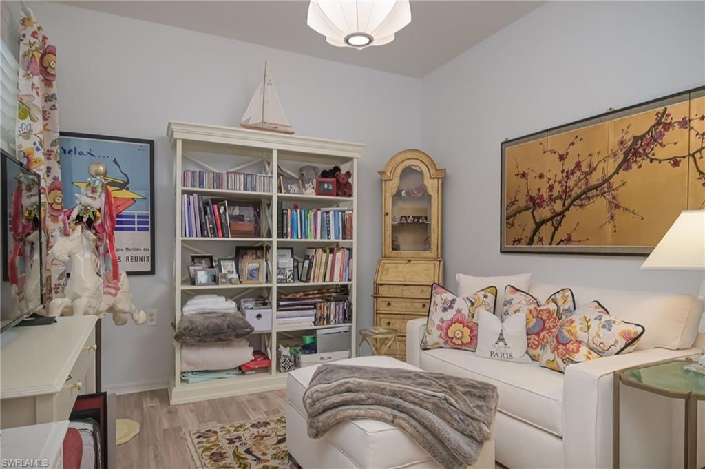 21533 Portrush Run Estero, FL 33928 - Photo 25 of 37 a bedroom with a bed and a book shelf