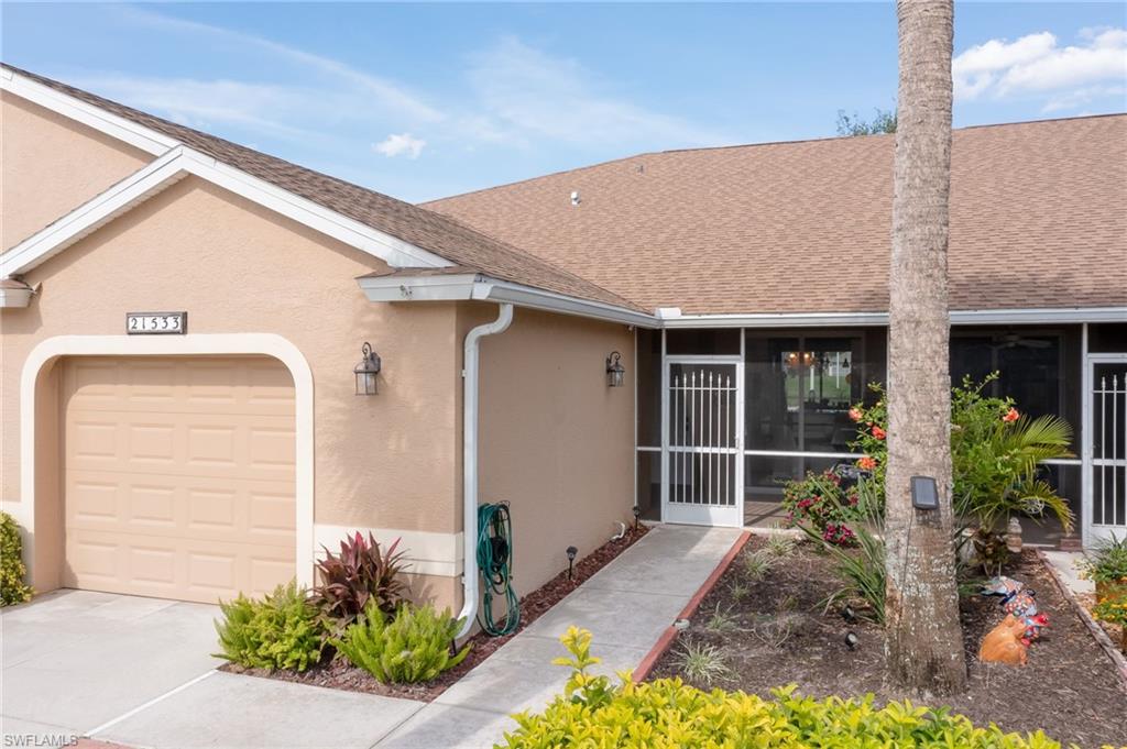 21533 Portrush Run Estero, FL 33928 - Photo 4 of 37 a front view of a house with garden