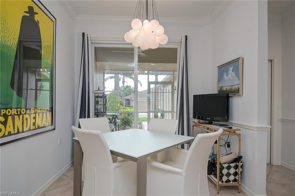 21533 Portrush Run Estero, FL 33928 - Photo 7 of 37 a room with chandelier furniture and a flat screen tv