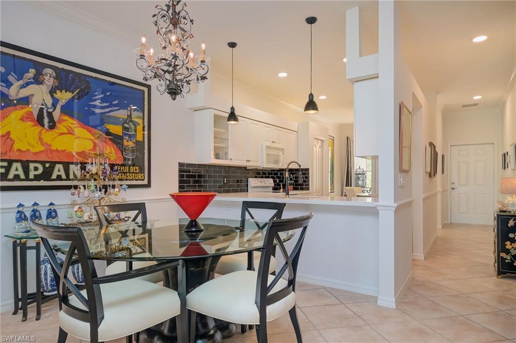 21533 Portrush Run Estero, FL 33928 - Photo 8 of 37 a dining room with furniture and chandelier