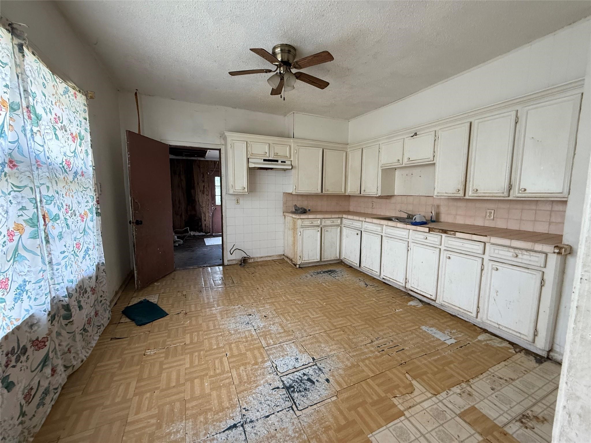 1709 Hussion Street Houston, TX 77003 - Photo 12 of 12 a kitchen with a sink a stove a refrigerator and cabinets