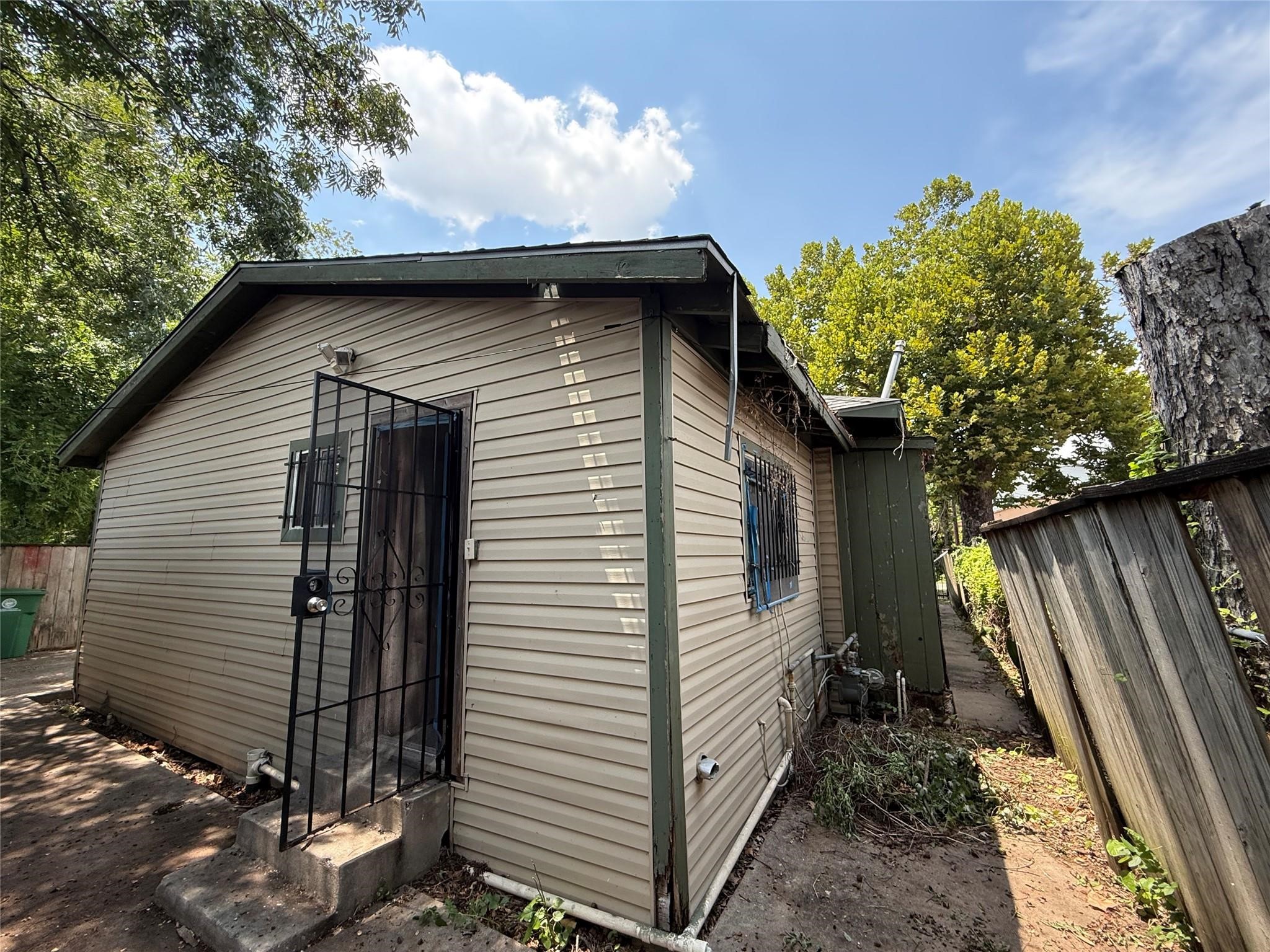 1709 Hussion Street Houston, TX 77003 - Photo 2 of 12 a yellow house with tree in front of it