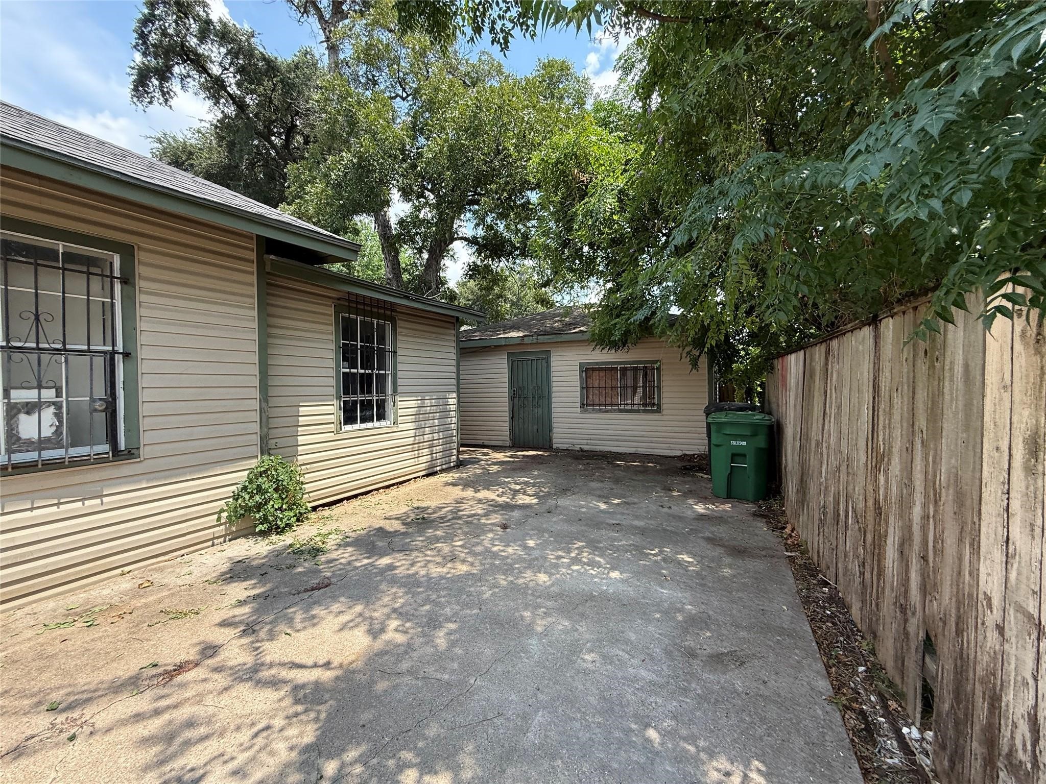 1709 Hussion Street Houston, TX 77003 - Photo 6 of 12 a view of a house with a small yard and a large tree