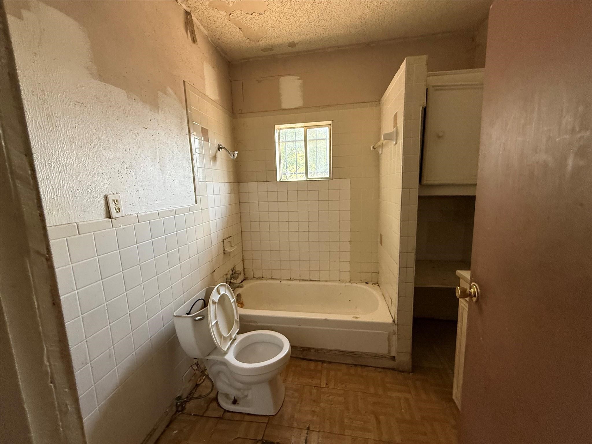 1709 Hussion Street Houston, TX 77003 - Photo 7 of 12 a bathroom with a granite countertop bathtub shower and toilet