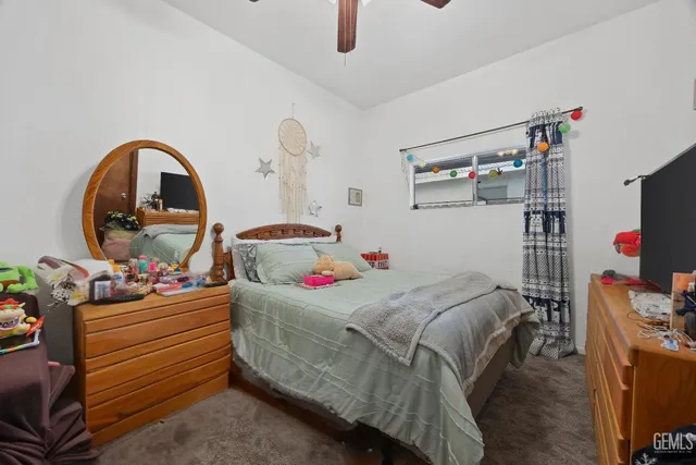 a bedroom with a bed and a tv