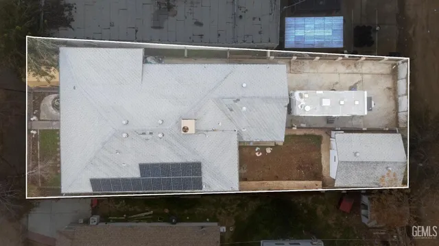 a view of a yard with table and chairs under an umbrella