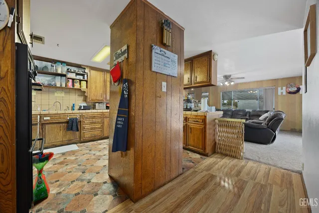 a view of a kitchen with furniture and wooden floor