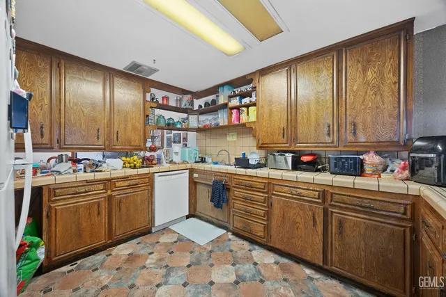 a kitchen with stainless steel appliances a sink stove and cabinets