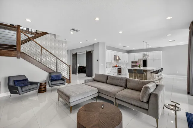 a large kitchen with stainless steel appliances lots of counter space and a sink