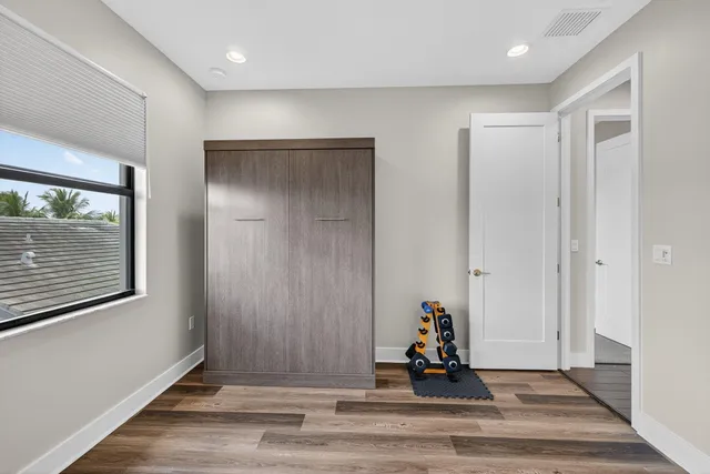 a spacious bedroom with a large bed and a flat screen tv