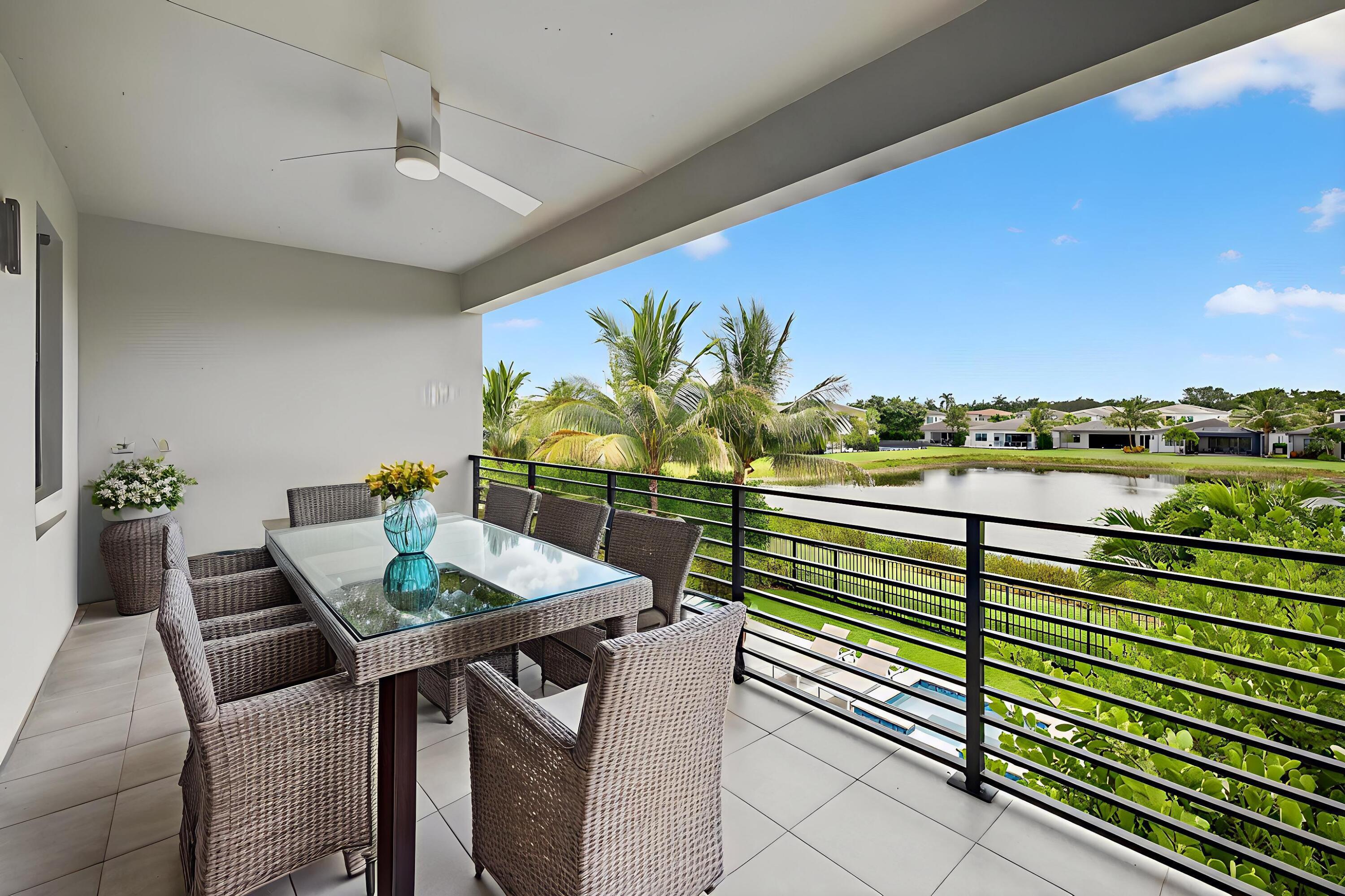 8618 Tower Bridge Court Boca Raton, FL 33496 - Photo 53 of 53 a view of a balcony with table and chairs and a potted plant