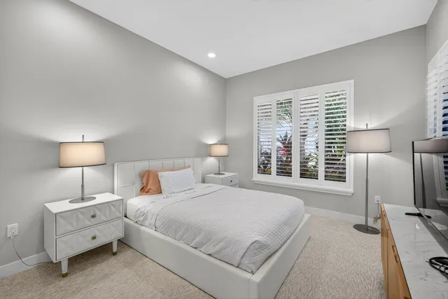 a bathroom with a toilet a sink a shower and mirror