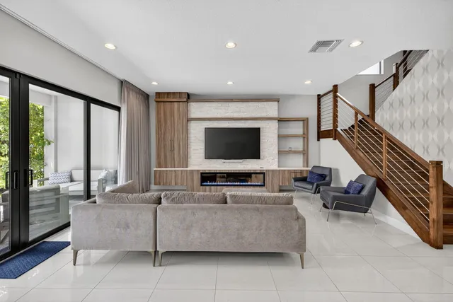 a living room with furniture and stairs